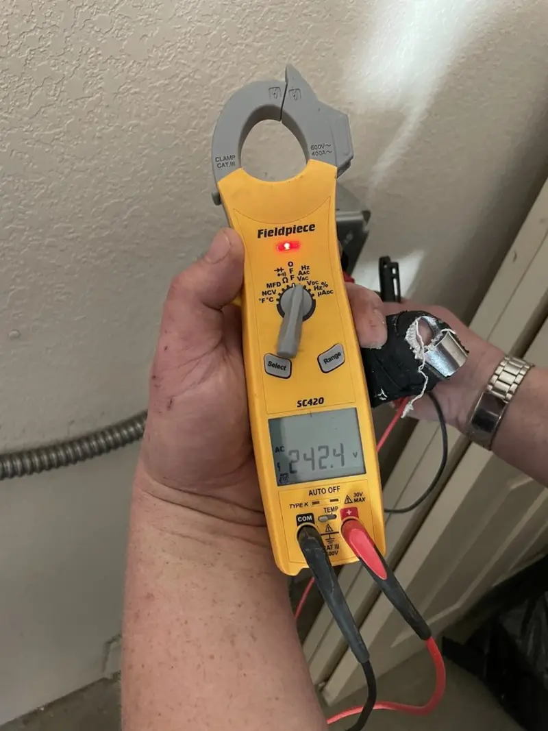 Voltage testing with clamp meter during Ceiling Fan Installation in Westborough